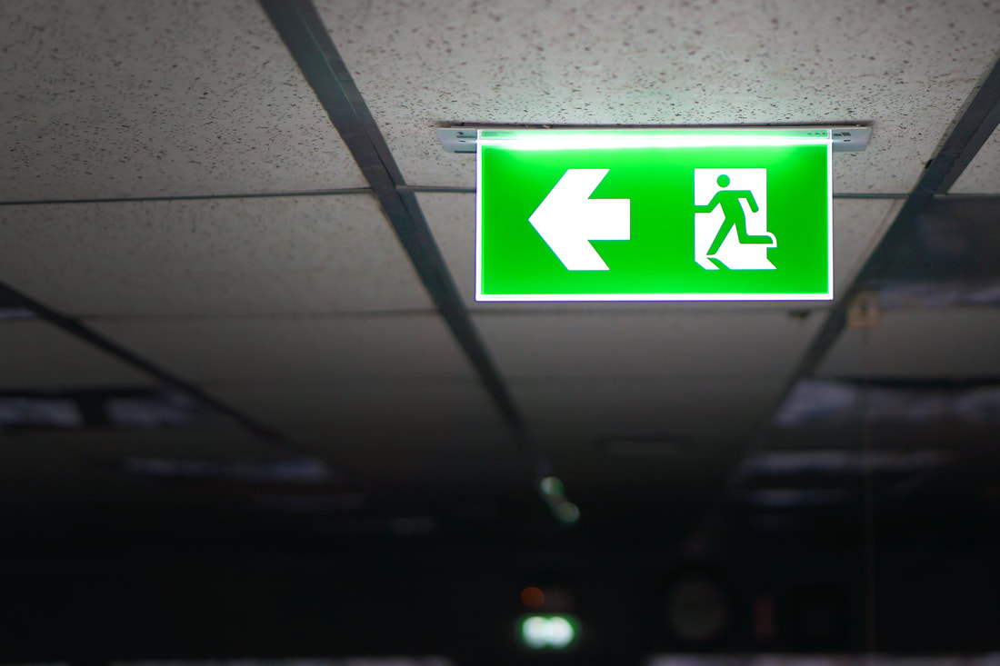 Green exit sign for a company in NJ